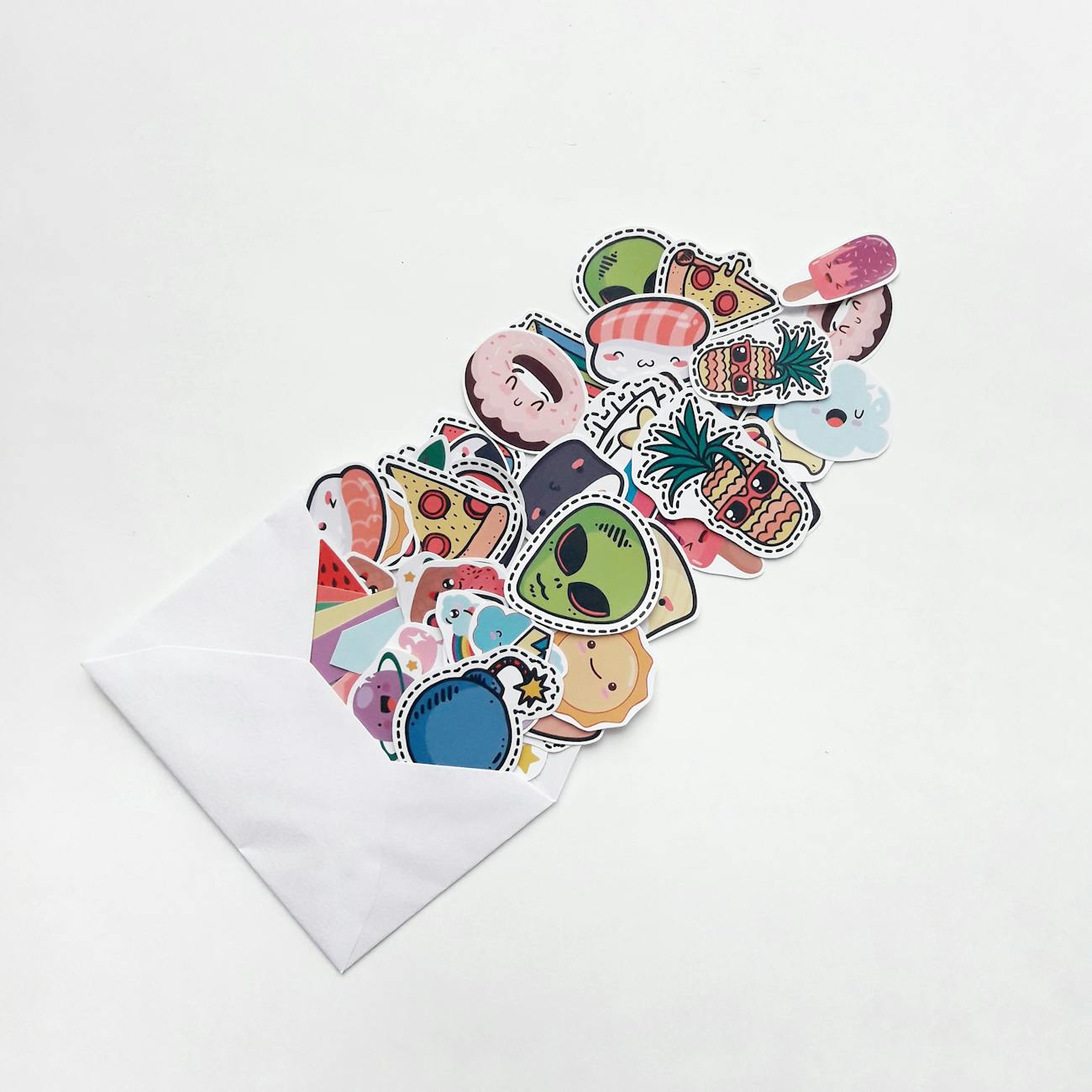 Colorful cartoon stickers spilling out of a white envelope.