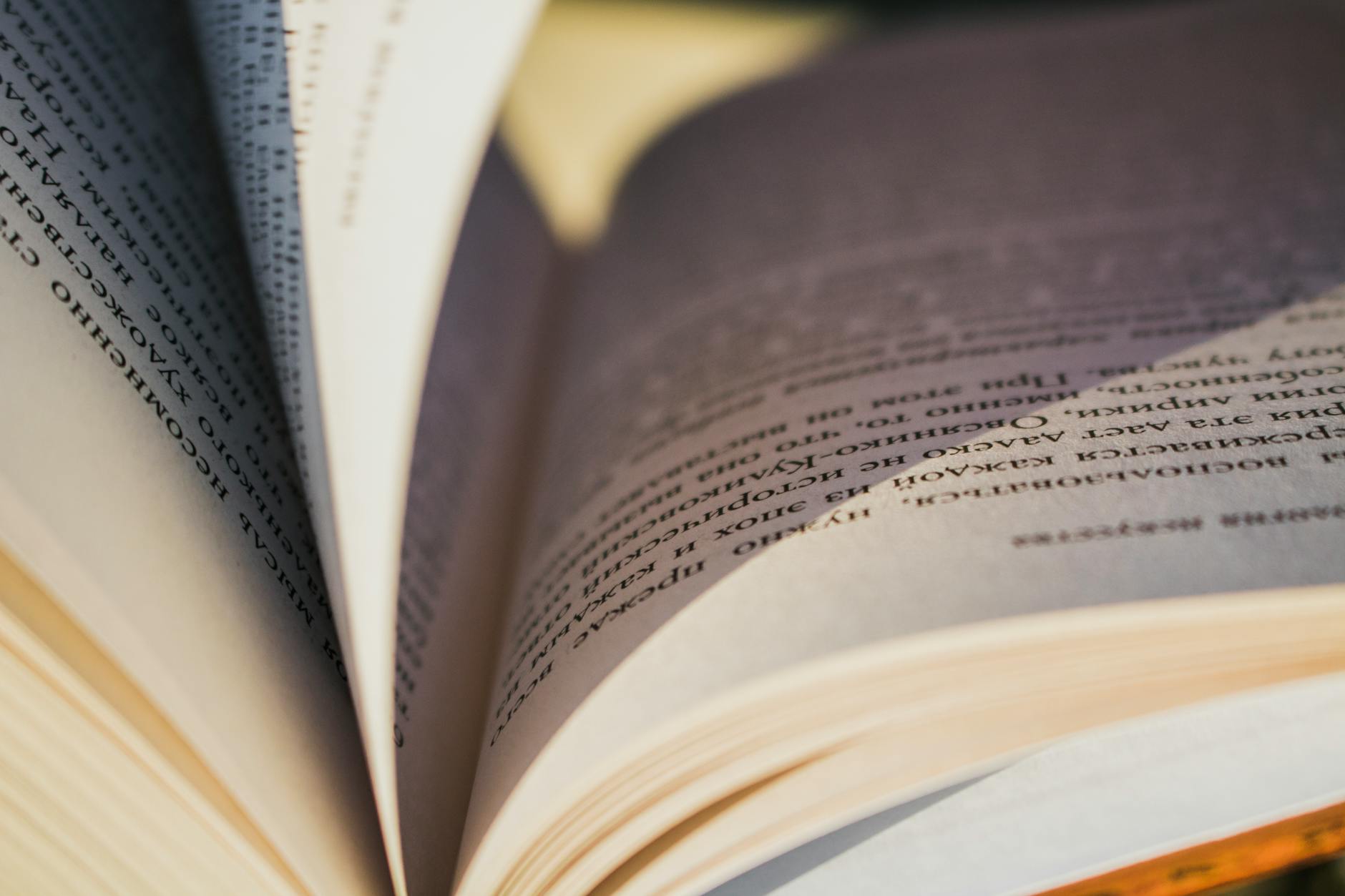 Detailed close-up image of an open book showing textured pages and printed text.