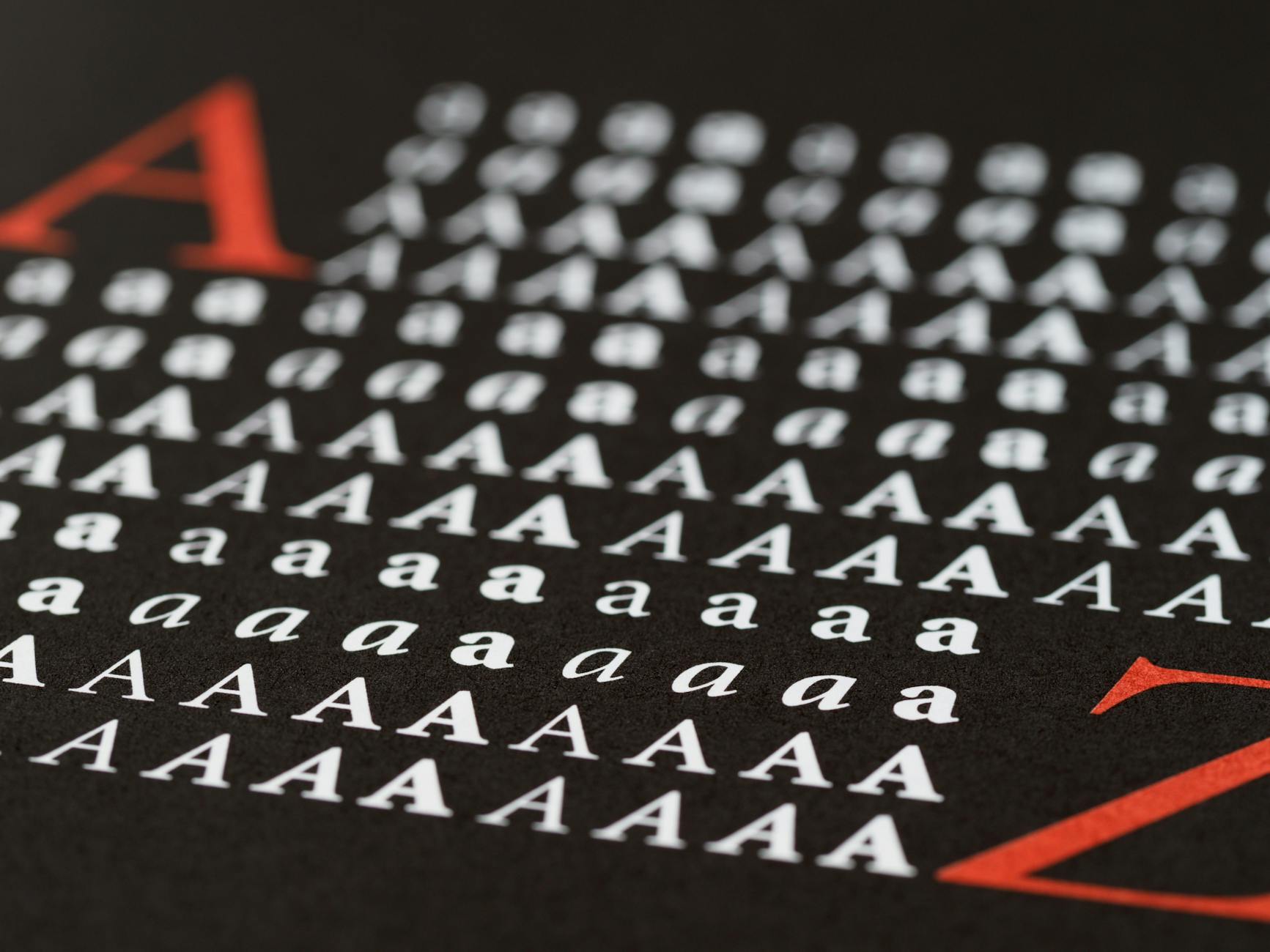 A printed poster with rows of red and white lettering.